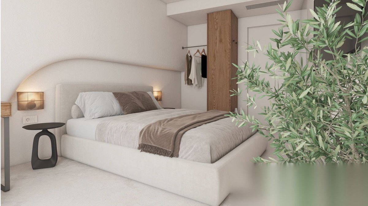 Serene bedroom suite with olive tree and soft natural light in a luxury Greek villa