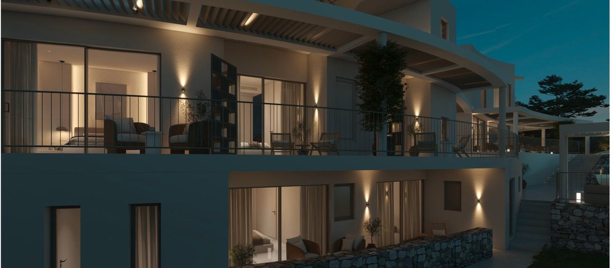 Curved villa facade with warm uplighting at dusk, luxury home in Sithonia, Greece