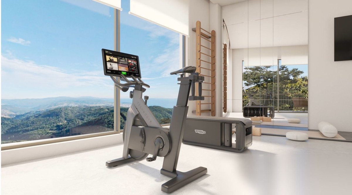 Home gym with Technogym equipment and panoramic mountain-and-sea views in a luxury villa